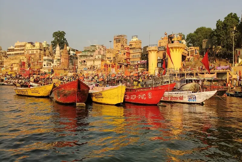 Colourful boats moored on the Ganges below the Varanasi ghats