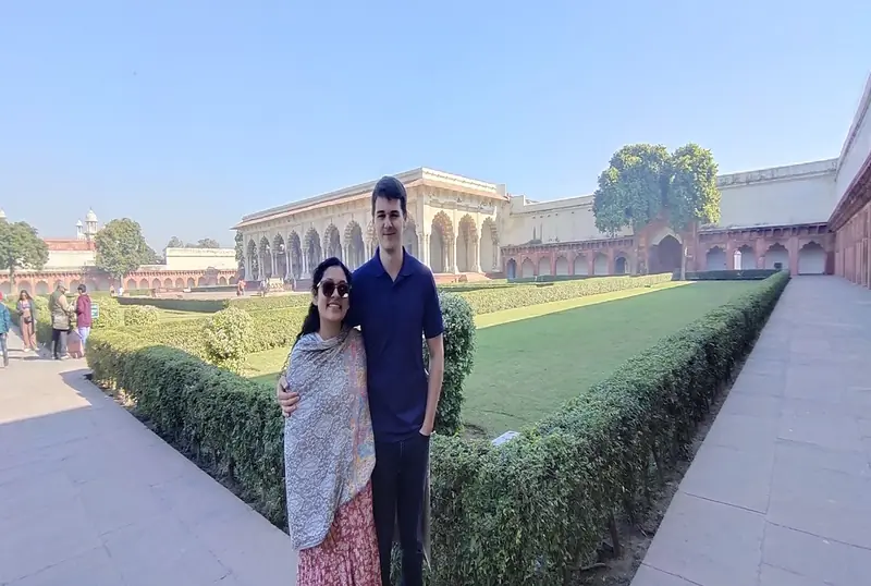 Couple standing by the gardens inside Agra Fort